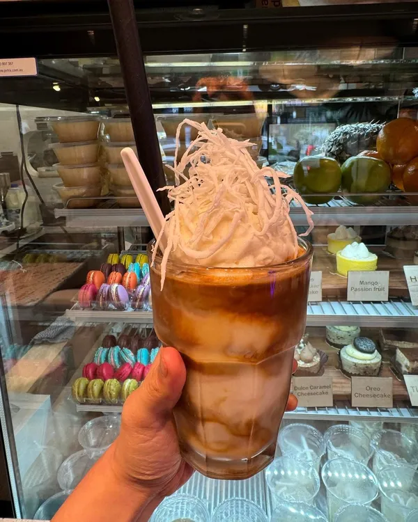 An iced coffee topped with shredded coconut